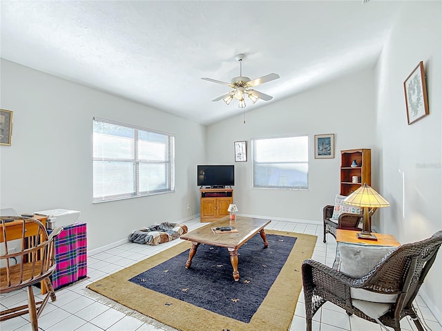 living room with light tile patterned floors, vaulted ceiling, a wealth of natural light, and ceiling fan