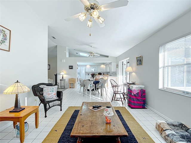 living room featuring ceiling fan, light tile patterned flooring, and vaulted ceiling