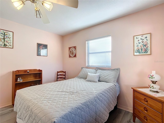 bedroom with hardwood / wood-style flooring and ceiling fan