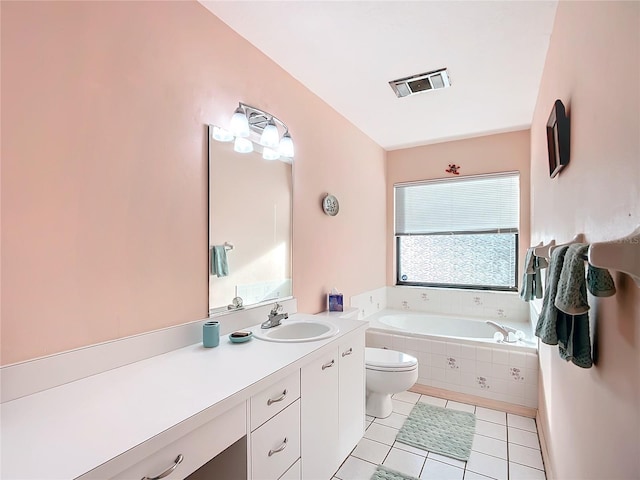 bathroom with tile patterned floors, tiled bath, vanity, and toilet