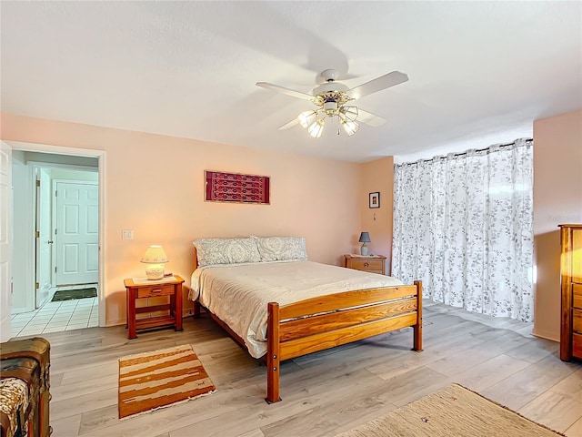 bedroom with ceiling fan and light hardwood / wood-style floors