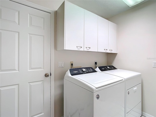 washroom featuring cabinets and independent washer and dryer