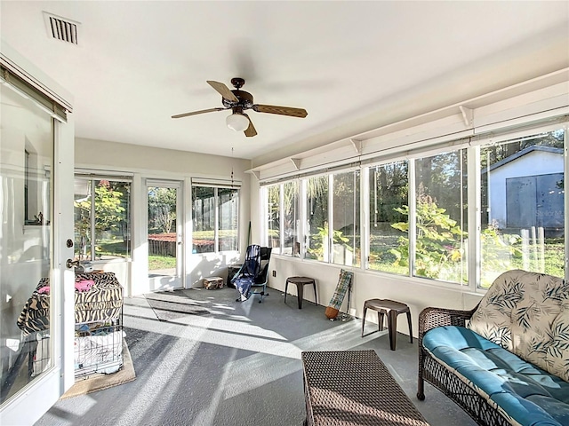 sunroom with ceiling fan and plenty of natural light