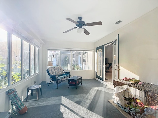 sunroom featuring ceiling fan