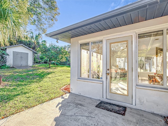 entrance to property with a lawn