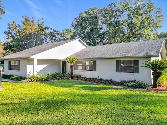 ranch-style home featuring a front lawn