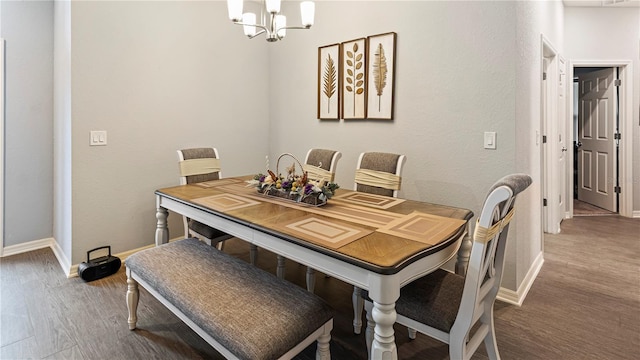 dining area with wood-type flooring and a chandelier