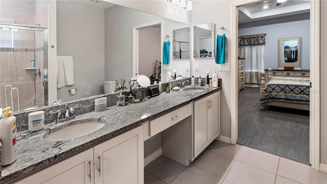 bathroom with tile patterned flooring, an enclosed shower, and vanity