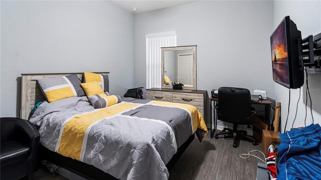 bedroom with dark wood-type flooring