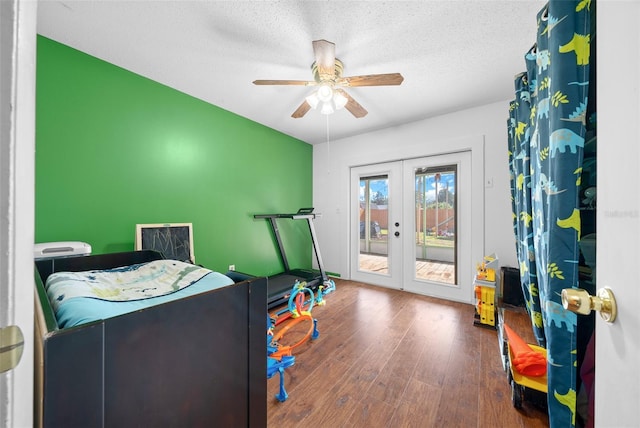 playroom with french doors, a textured ceiling, ceiling fan, and hardwood / wood-style floors