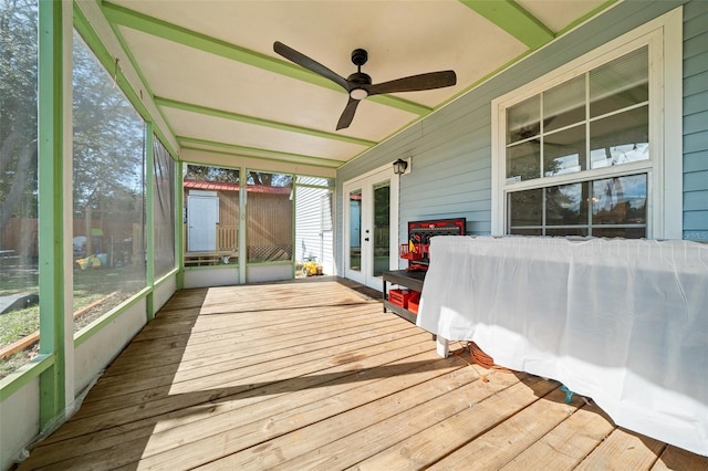 unfurnished sunroom featuring ceiling fan