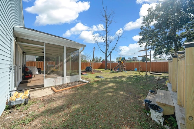 view of yard featuring a playground and a sunroom