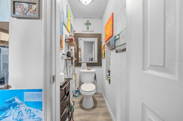 bathroom with wood-type flooring and toilet