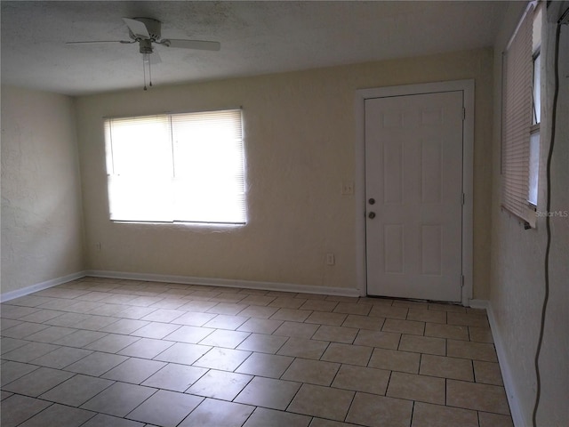 tiled foyer with ceiling fan