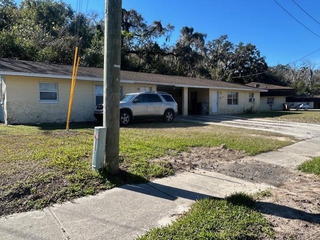 view of side of home with a lawn