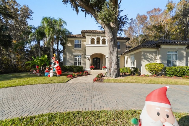 mediterranean / spanish-style house with a front yard