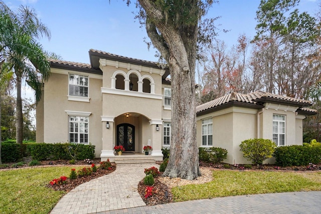 mediterranean / spanish-style house with french doors