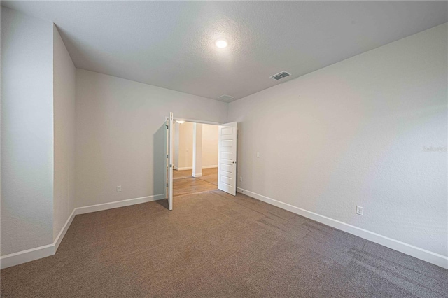 unfurnished bedroom featuring carpet and a textured ceiling