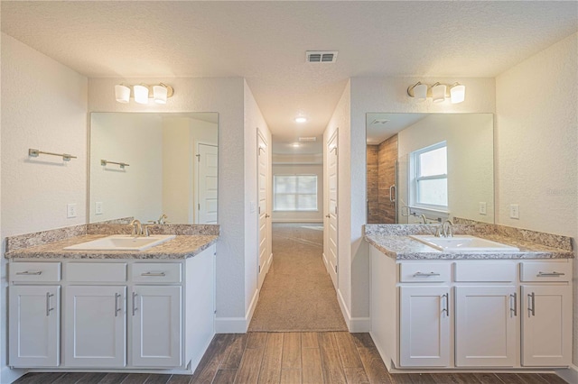 bathroom featuring vanity and a textured ceiling