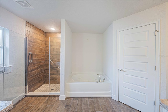 bathroom featuring plus walk in shower