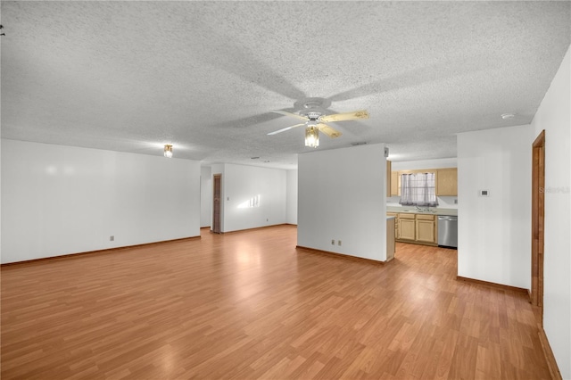 unfurnished living room featuring ceiling fan, light hardwood / wood-style flooring, a textured ceiling, and sink