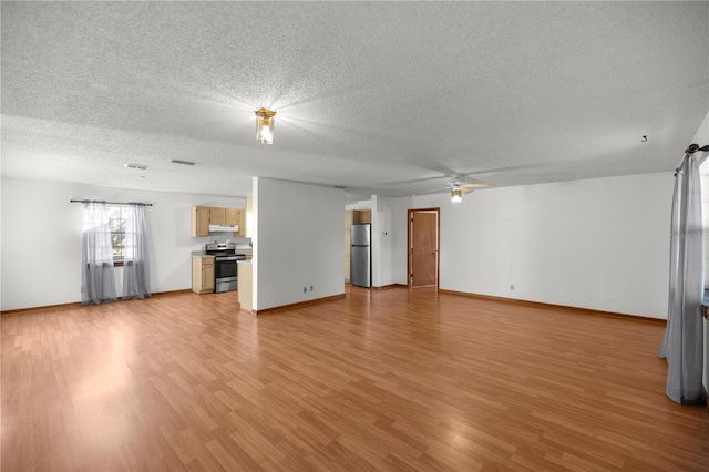 unfurnished living room with a textured ceiling and light hardwood / wood-style flooring