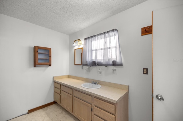 bathroom with vanity and a textured ceiling