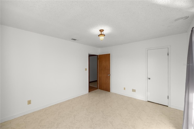 spare room featuring a textured ceiling