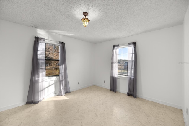 spare room featuring a textured ceiling