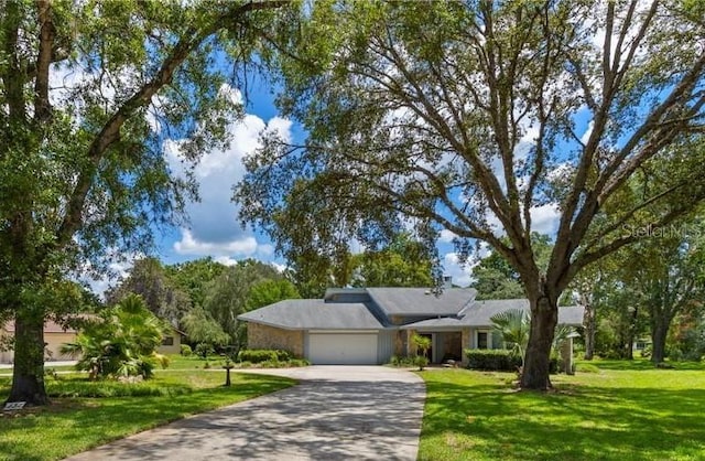 ranch-style home with a front yard and a garage