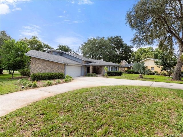 single story home with a garage and a front lawn