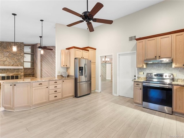 kitchen with pendant lighting, high vaulted ceiling, ceiling fan, light hardwood / wood-style floors, and stainless steel appliances