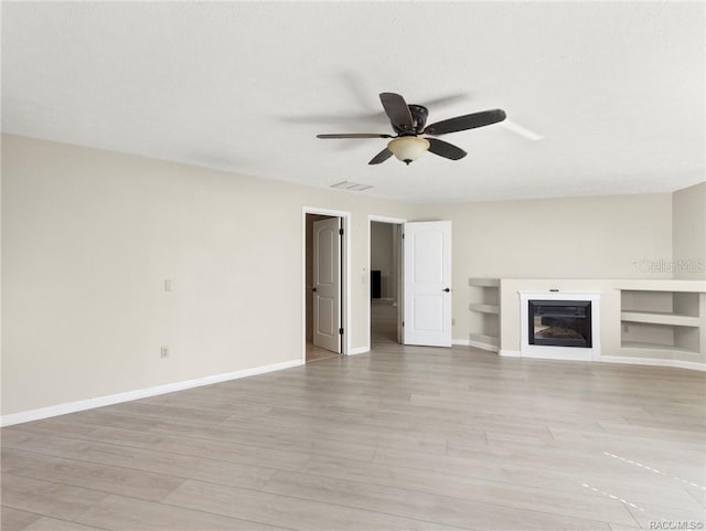 unfurnished living room featuring light hardwood / wood-style floors and ceiling fan