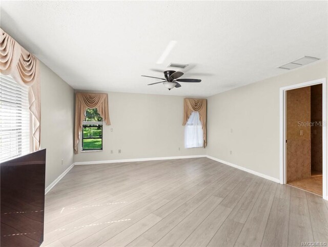 unfurnished room with light hardwood / wood-style flooring and ceiling fan