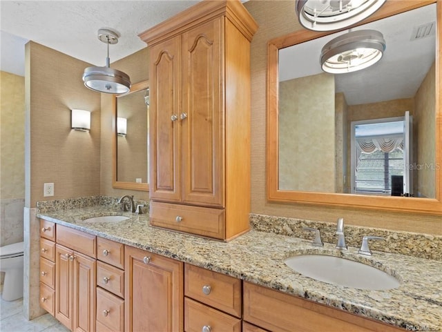 bathroom featuring tile patterned flooring, vanity, and toilet