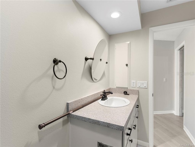 bathroom featuring vanity and wood-type flooring