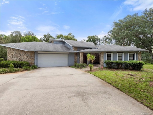 single story home with a garage and a front lawn