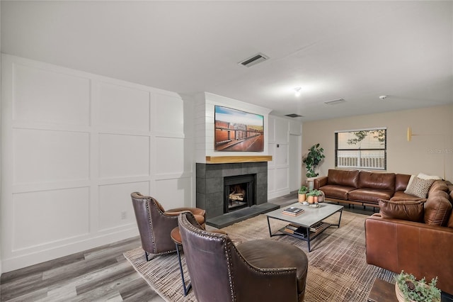 living room with hardwood / wood-style floors and a tile fireplace