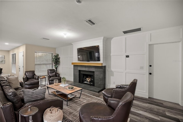 living room featuring dark hardwood / wood-style flooring and a fireplace