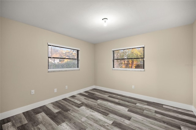 unfurnished room featuring dark hardwood / wood-style floors