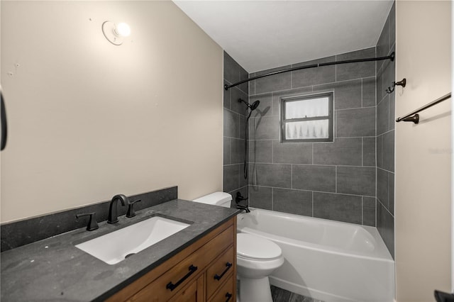 full bathroom with vanity, tiled shower / bath combo, and toilet