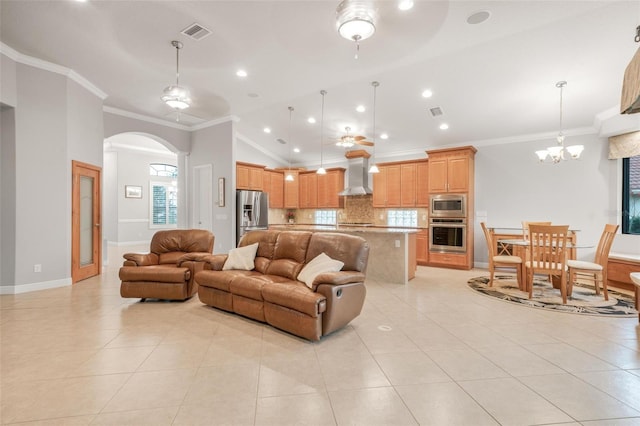 tiled living room featuring ceiling fan with notable chandelier, crown molding, and lofted ceiling