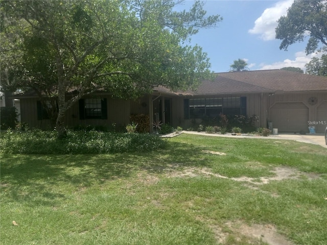 view of front of house featuring a garage and a front lawn