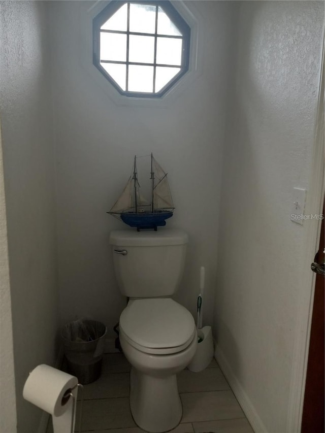 bathroom featuring toilet and tile patterned floors