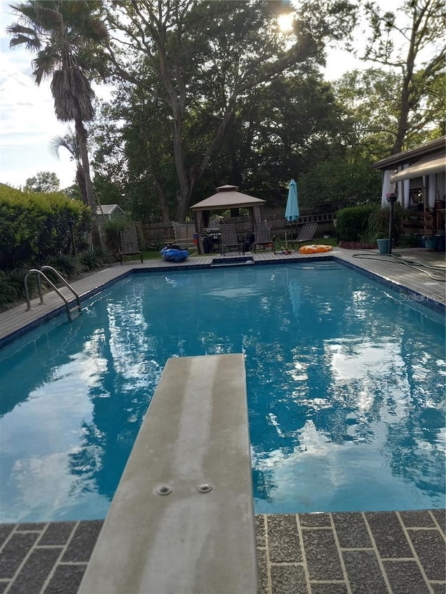 view of pool featuring a patio and a diving board