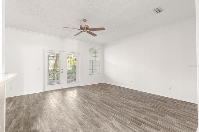 interior space with ceiling fan, ornamental molding, a textured ceiling, and french doors