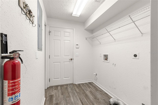 laundry room featuring hookup for an electric dryer, hookup for a washing machine, a textured ceiling, and hardwood / wood-style floors