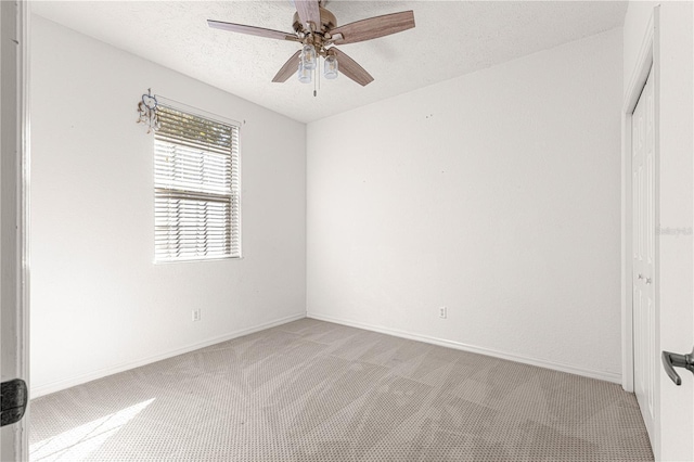 unfurnished bedroom with a textured ceiling, light colored carpet, and ceiling fan