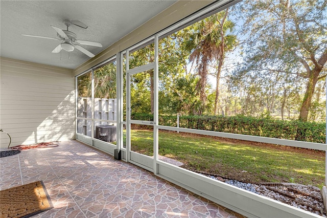 unfurnished sunroom featuring ceiling fan