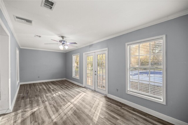 empty room with ceiling fan, french doors, crown molding, and hardwood / wood-style flooring